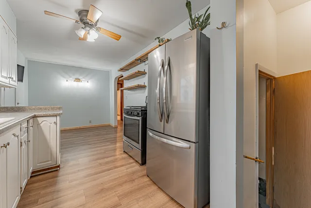 a view of a refrigerator in kitchen and wooden floor