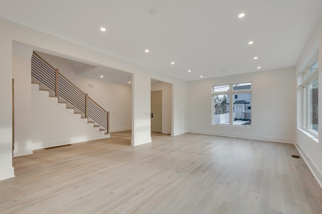 9 Richard Road Needham, MA 02492 - Photo 6 of 31 a view of an empty room with a window and wooden floor
