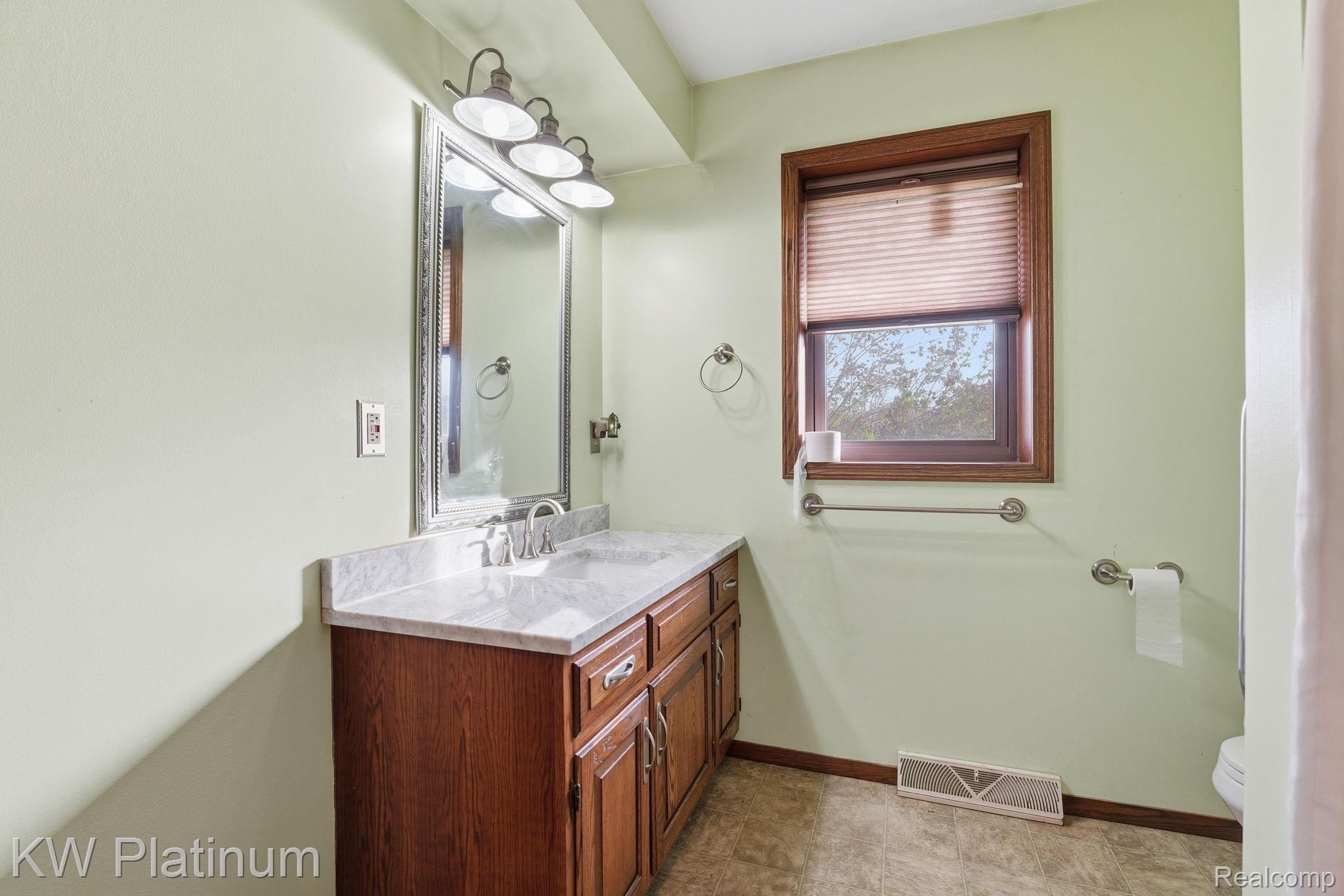 7383 Fisher Road Jeddo, MI 48032 - Photo 14 of 40 Bathroom featuring vanity and baseboards