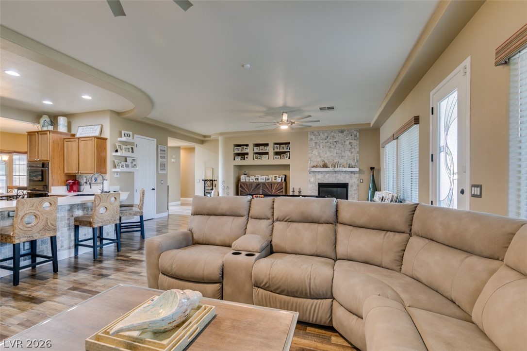 7524 Midnight Rambler Street Las Vegas, NV 89149 - Photo 17 of 51 An inviting open-concept living area boasts a modern kitchen with a breakfast bar, seamlessly flowing into a comfortable great room with a fireplace.