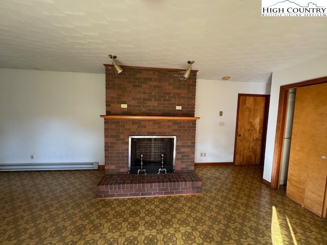427 J E Gentry Road Crumpler, NC 28617 - Photo 12 of 30 a view of a livingroom with a fireplace and a fireplace