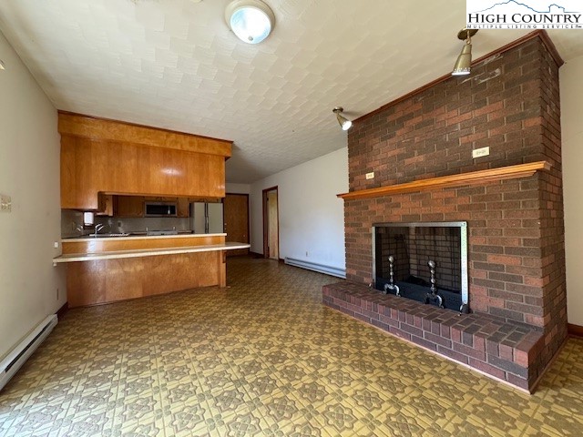 427 J E Gentry Road Crumpler, NC 28617 - Photo 13 of 30 a room with furniture and a fireplace