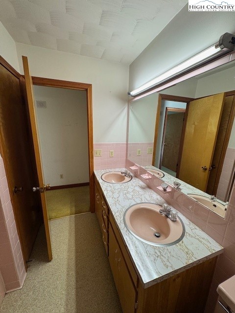 427 J E Gentry Road Crumpler, NC 28617 - Photo 26 of 30 a bathroom with a granite countertop sink and a mirror