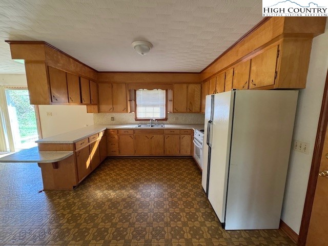 427 J E Gentry Road Crumpler, NC 28617 - Photo 10 of 30 a view of a kitchen with refrigerator and a sink