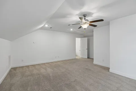 an empty room with fan and a ceiling fan