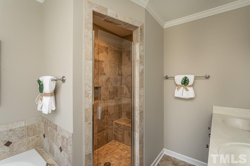 Gorgeous TILED walk-in shower with a bench seat, dual vanities and WHIRLPOOL tub; everything you need!