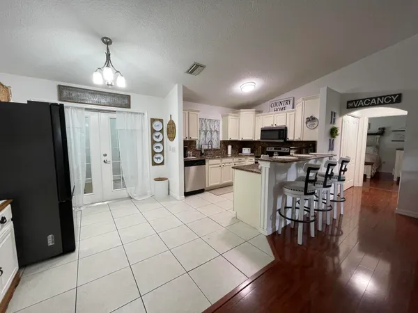 a kitchen with stainless steel appliances a refrigerator a stove top oven and a center island