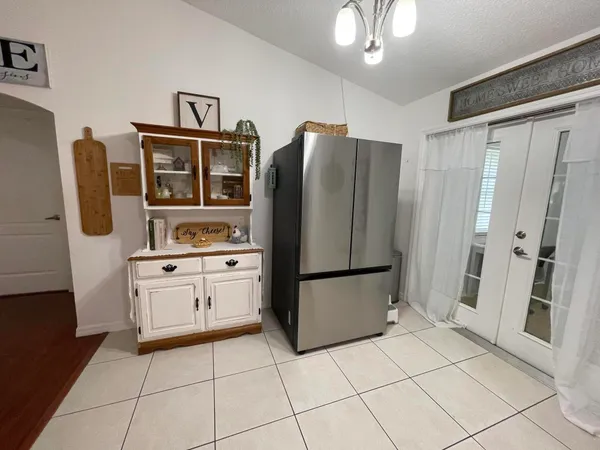 a kitchen with stainless steel appliances a refrigerator sink and cabinets