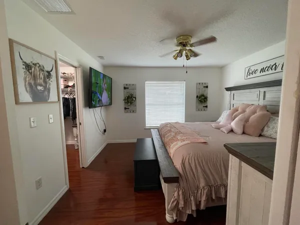 a bedroom with a bed and a flat screen tv