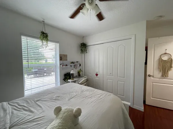 a bed room with a bed window and a chandelier