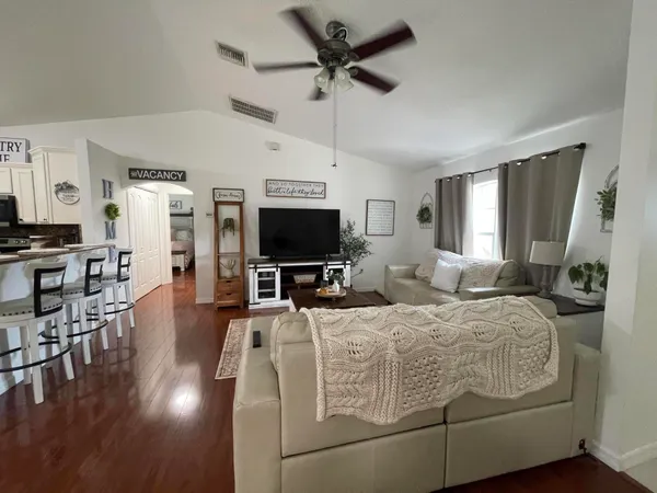 a living room with furniture and a flat screen tv