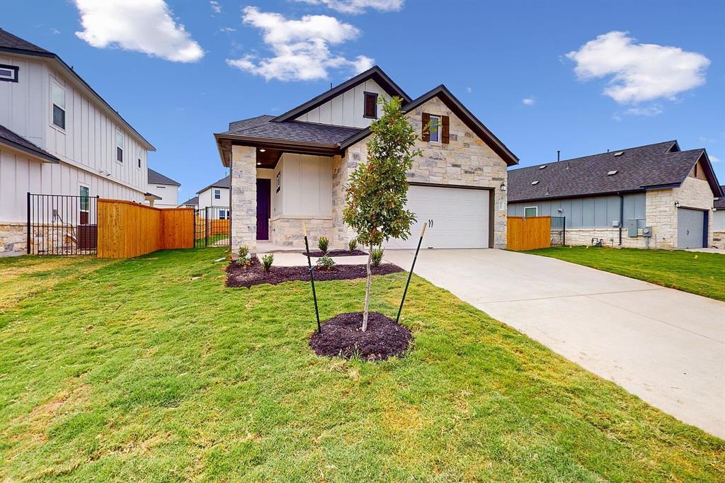 4907 Escape Rivera Drive Austin, TX 78747 - Photo 2 of 28 A newly constructed residence features a spacious driveway and attached garage.