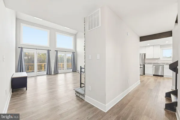 a view of staircase with wooden floor and white walls