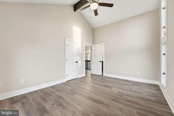 an empty room with furniture and wooden floor