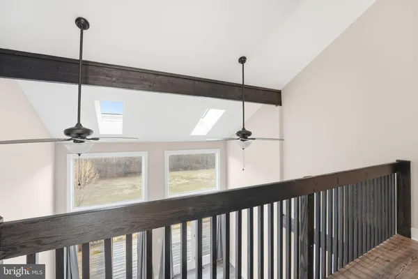 a view of a hallway with wooden floor and glass door