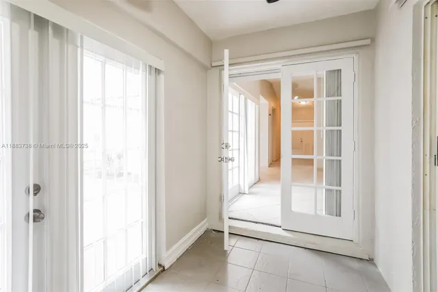 a view of room with window and a ceiling fan