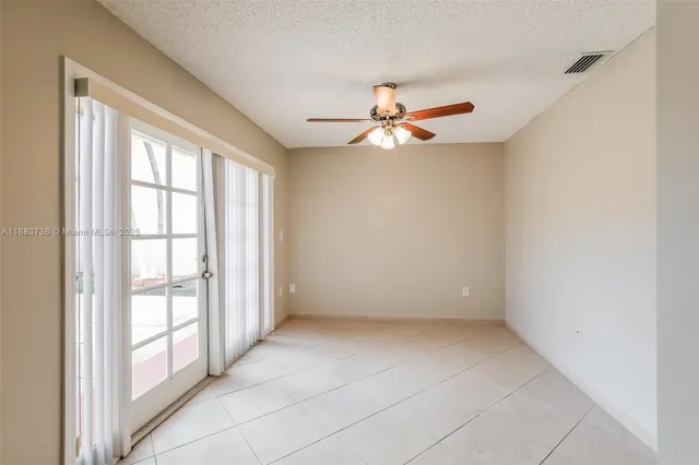 a kitchen with granite countertop a refrigerator and a stove top oven