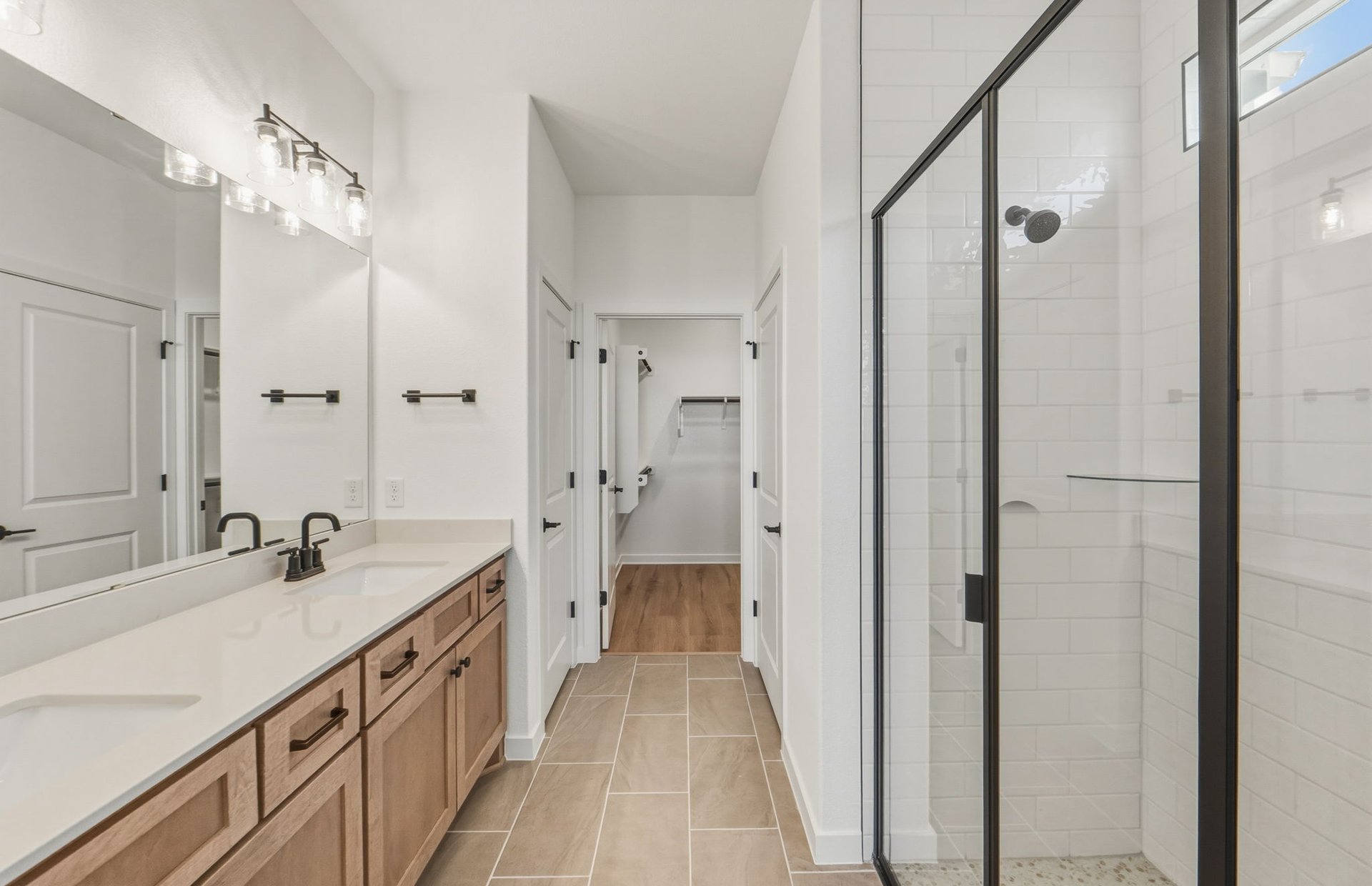 207 Smokestack Lane Georgetown, TX 78633 - Photo 8 of 21 a bathroom with a double vanity sink a mirror and a shower