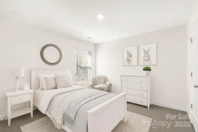 a bedroom with a bed and a lamp