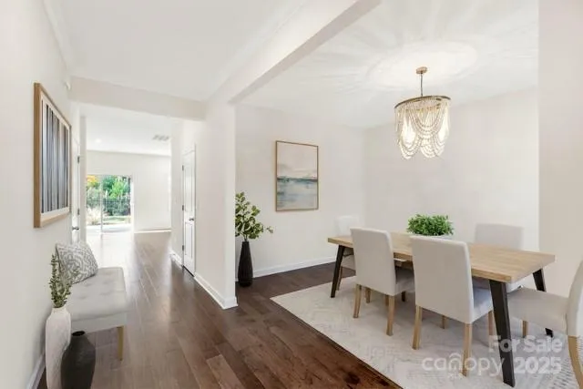 a view of a dining room with furniture wooden floor and a chandelier