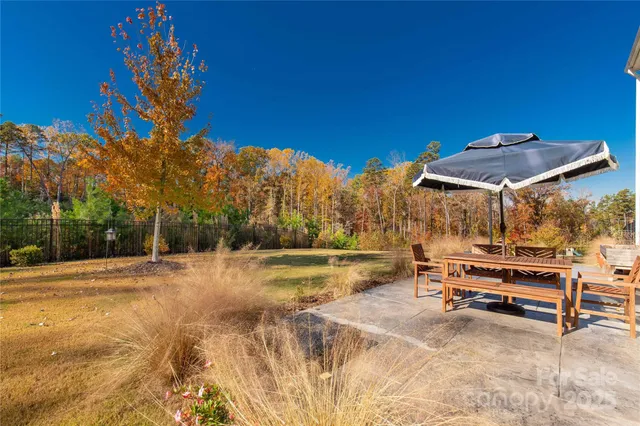 a view of a backyard with swimming pool