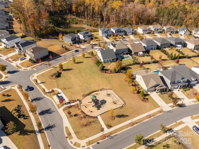 an aerial view of a residential houses with outdoor space