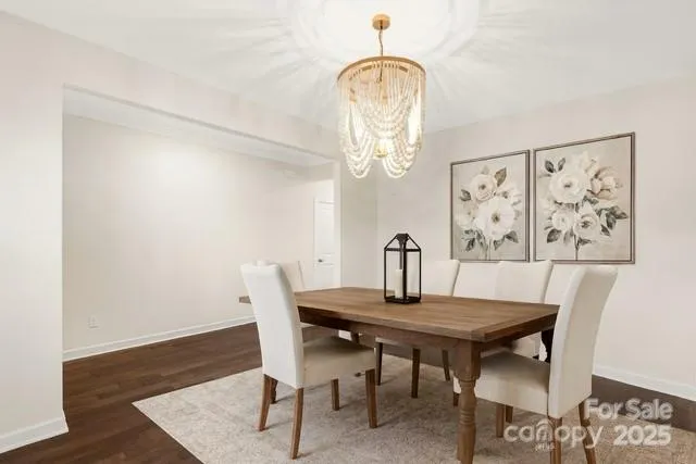 a dining room with wooden floor and breakfast area