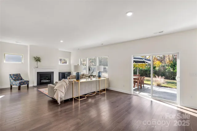 a living room with furniture fireplace and window