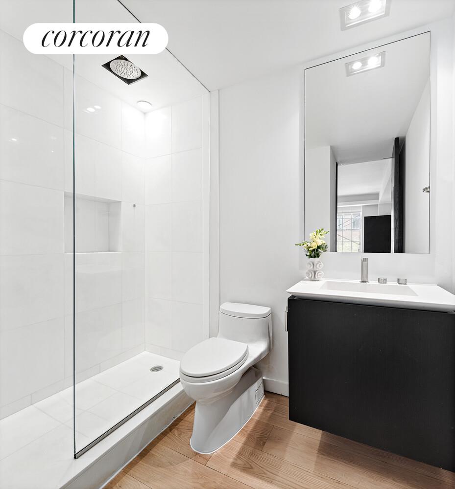 110 East 71st Street, Unit 4 Manhattan, NY 10021 - Photo 13 of 22 a bathroom with a sink a toilet and shower