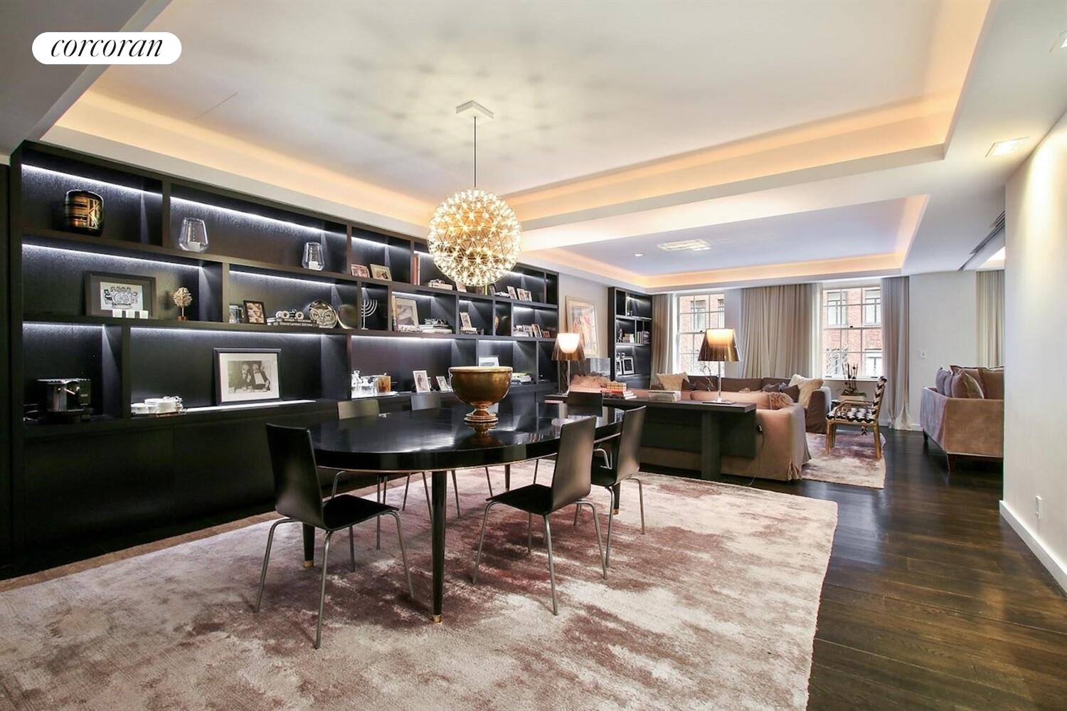 110 East 71st Street, Unit 4 Manhattan, NY 10021 - Photo 16 of 22 a living room with furniture a chandelier and a dining table