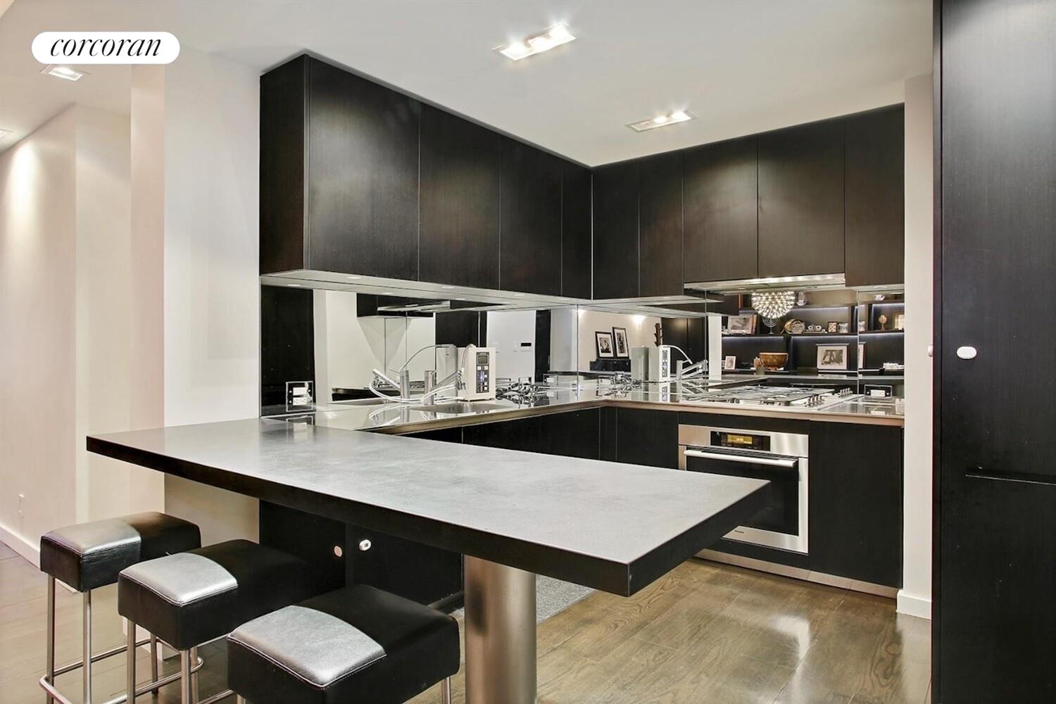 110 East 71st Street, Unit 4 Manhattan, NY 10021 - Photo 6 of 22 a kitchen with stainless steel appliances a sink and stove