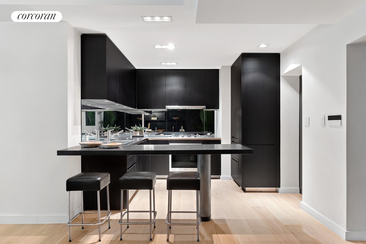 110 East 71st Street, Unit 4 Manhattan, NY 10021 - Photo 8 of 22 a kitchen with a sink and chairs