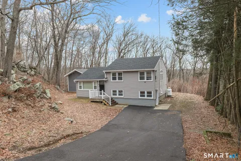 a view of a house with a yard covered in snow