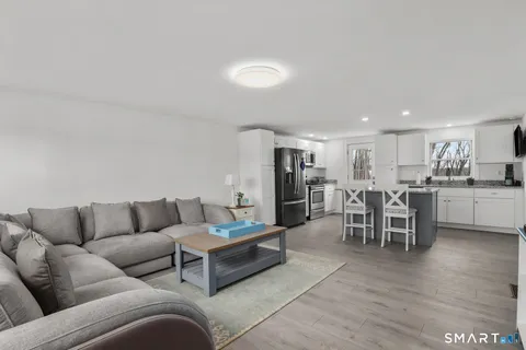 a living room with furniture kitchen view and a dining table