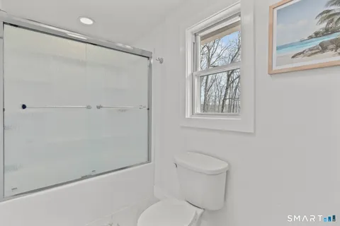 a bathroom with a toilet and a shower