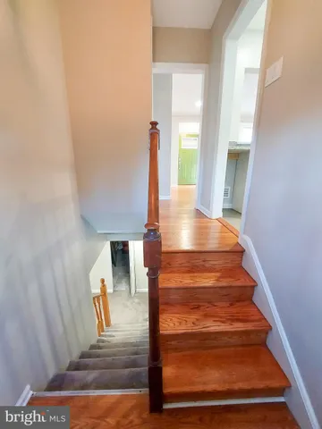a view of entryway and hall with wooden floor