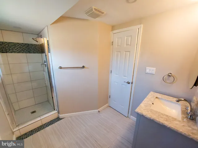 a bathroom with a sink and shower