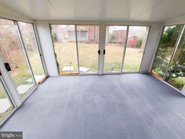 a view of an empty room with a floor to ceiling window