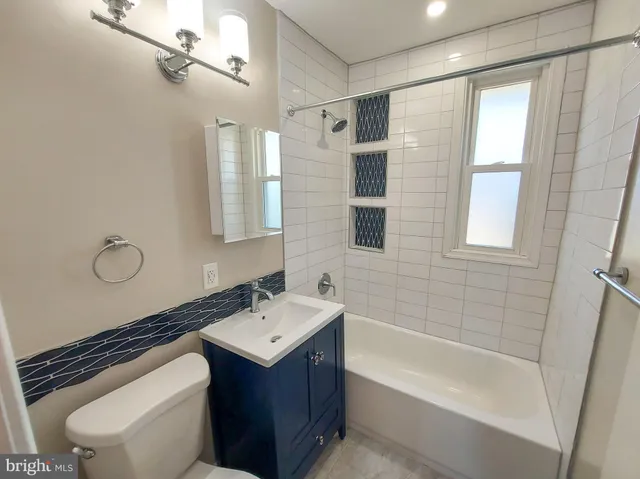 a bathroom with a sink a toilet and bathtub
