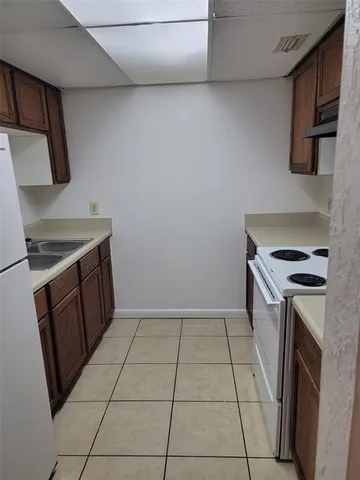 a kitchen with a stove top oven and cabinets