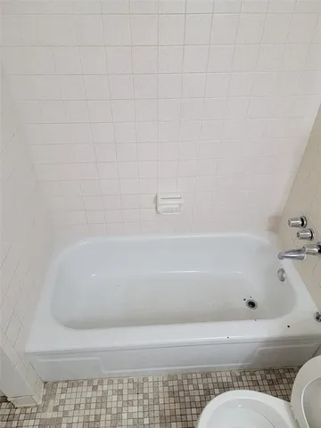 a bathroom with a bathtub and a toilet