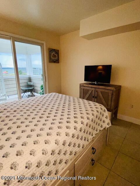 438 Highway 35, Unit 5305 Mantoloking, NJ 08738 - Photo 27 of 40 a bedroom with a bed and wooden floor