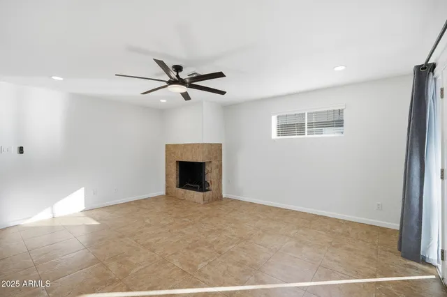 a kitchen with stainless steel appliances granite countertop a sink a stove a refrigerator and island with wooden floor