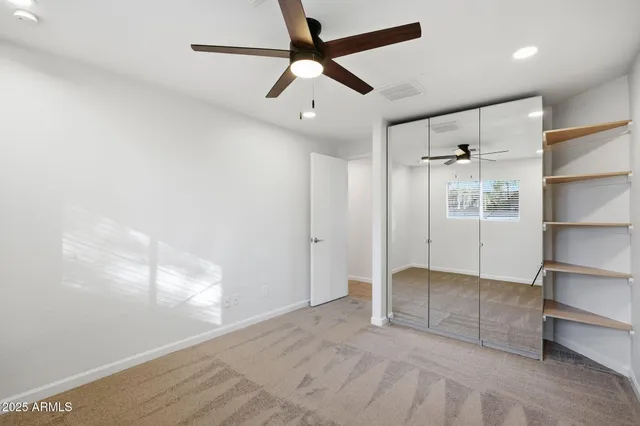 a bathroom with a bathtub shower sink vanity and toilet