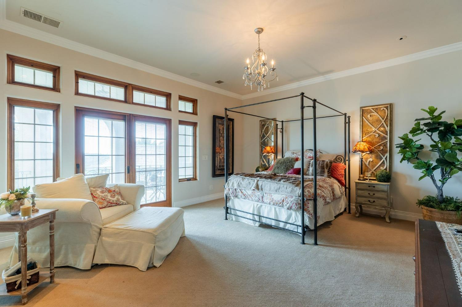 1140 Cold Springs Road Placerville, CA 95667 - Photo 55 of 98 a spacious bedroom with bed and a chandelier