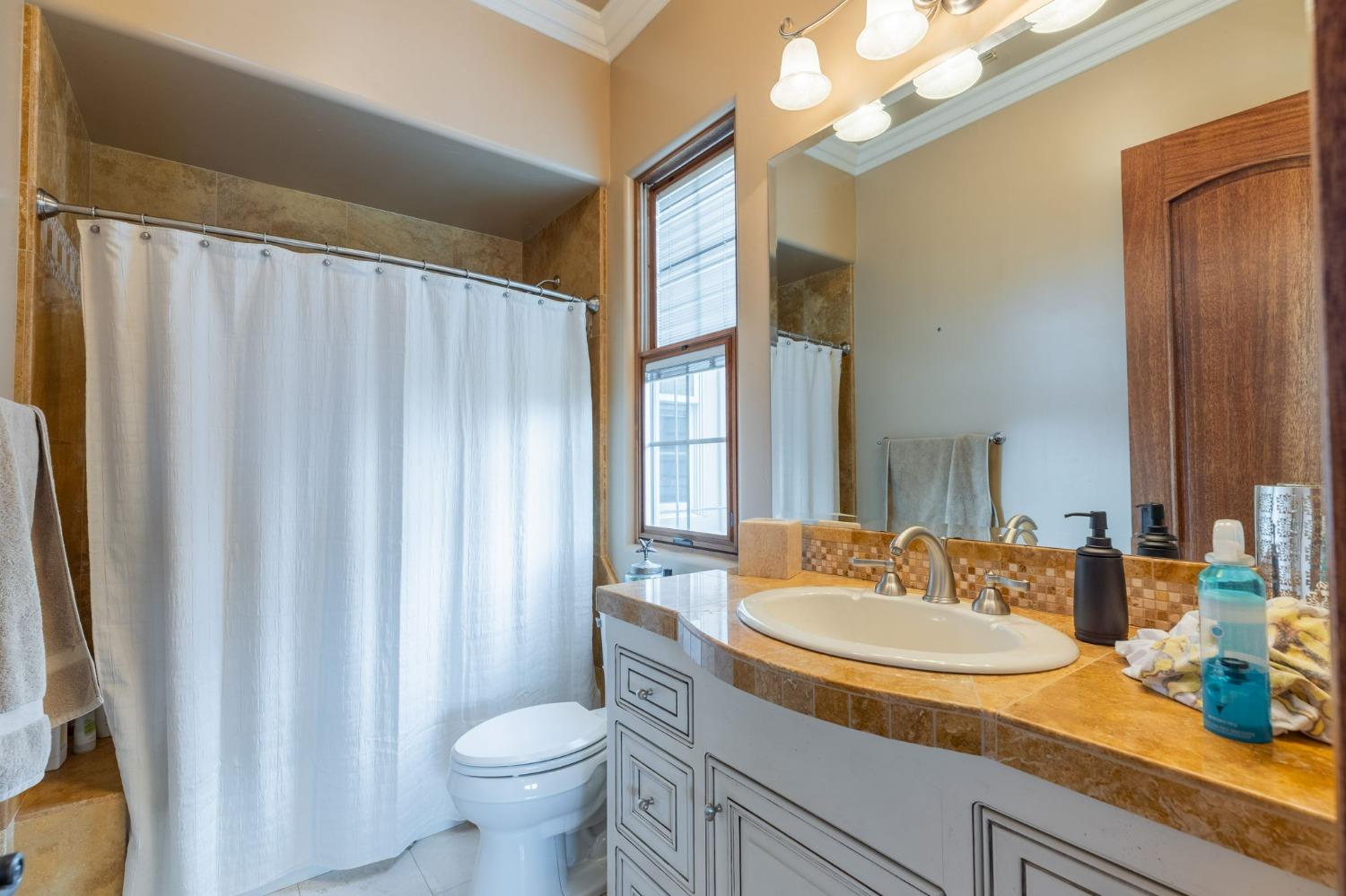 1140 Cold Springs Road Placerville, CA 95667 - Photo 62 of 98 a bathroom with a granite countertop sink toilet and a mirror