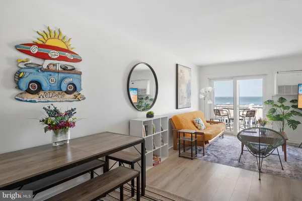 a dining room with furniture potted plants and wooden floor