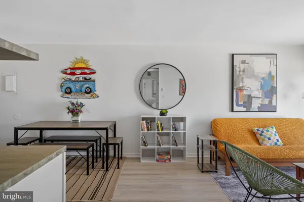 a bedroom with two beds and painting on the wall