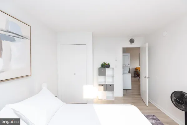 a bedroom with two beds and a chair