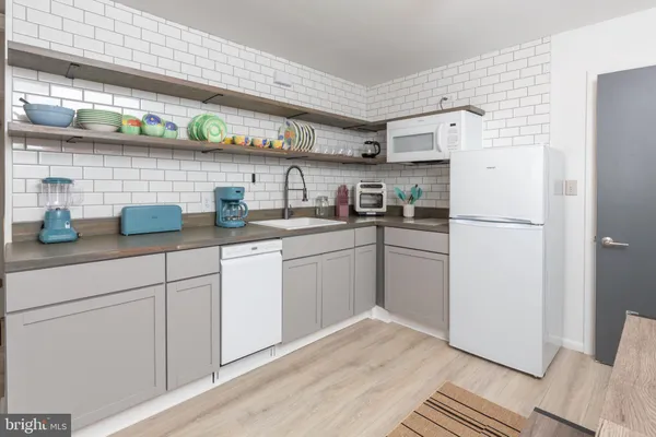 a bathroom with a sink a toilet and shower curtain